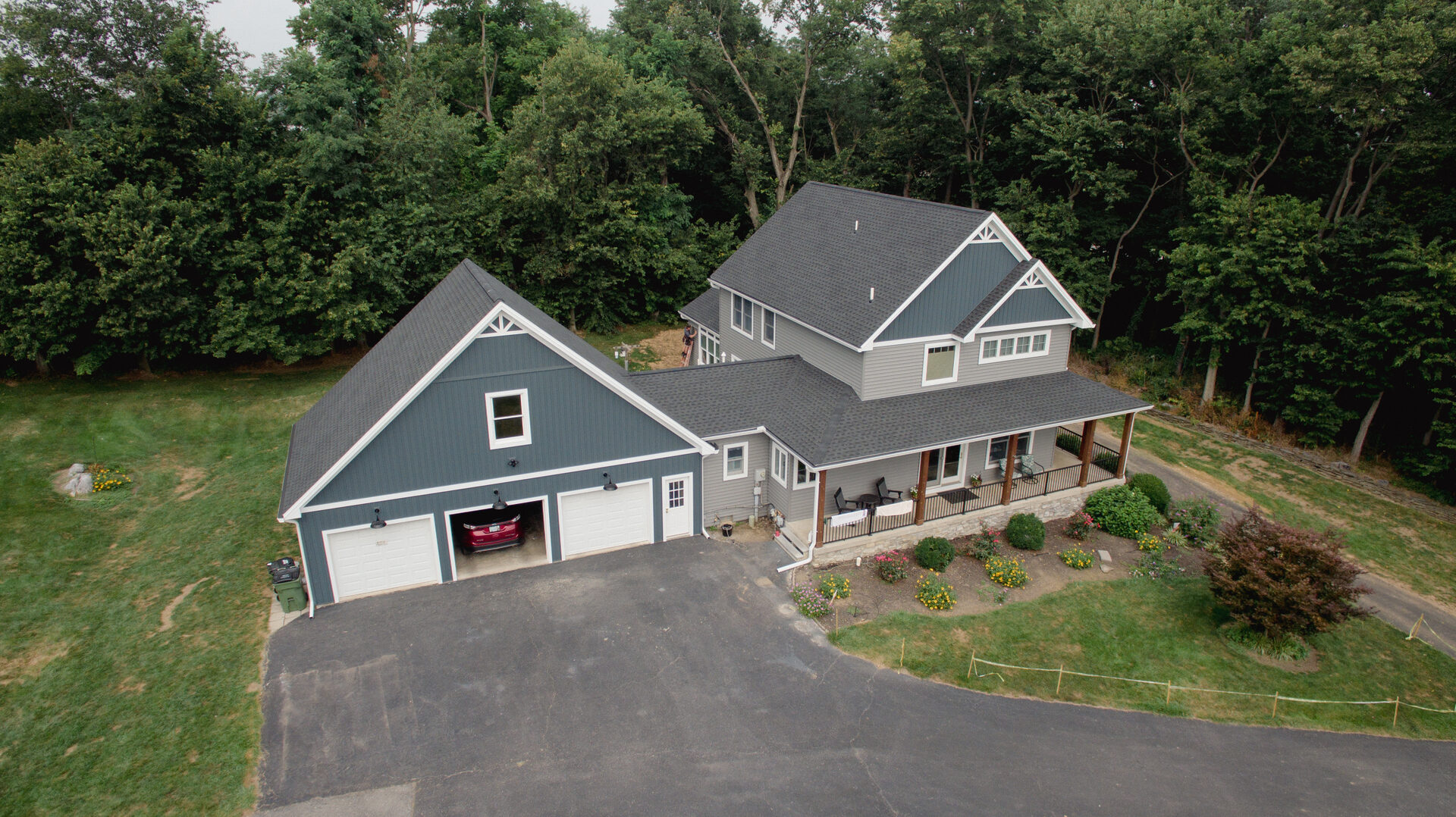Aerial view of a craftsman-style home with attached garage