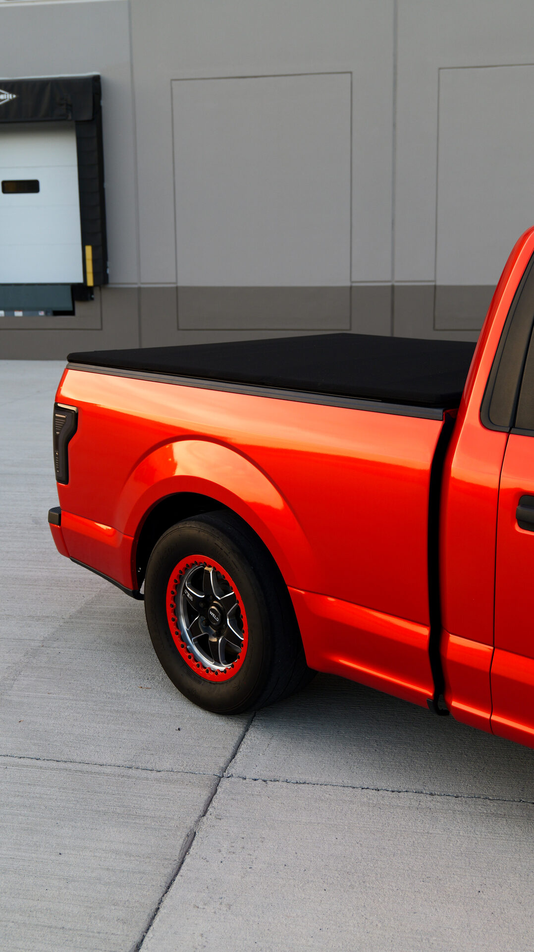 Rear quarter of red truck with tonneau cover
