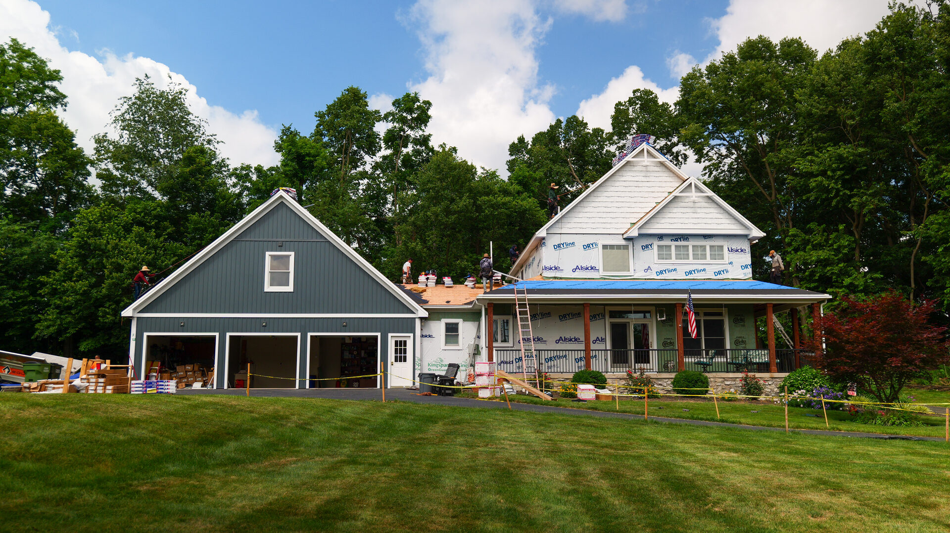Home under construction with crew working on the roof